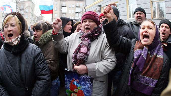 Pro-Russian activists demonstrate in front of riot policemen standing guard in front of the regional administration in Donetsk on March 3, 2014. (AFP Photo / Alexander Khudoteply)