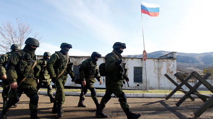 Armed men believed to be Russian servicemen march outside a Ukrainian military unit in the village of Perevalnoye outside Simferopol, March 5, 2014. (Reuters / Vasily Fedosenko)