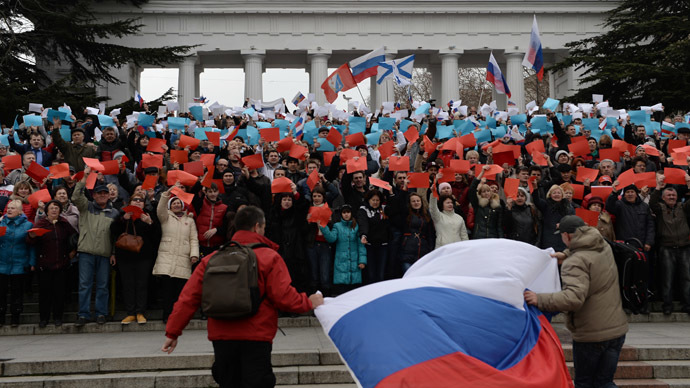 Participants hold different-colored pieces of paper to display the Russian flag at the rally in support of the Crimean Parliament and Sevastopol City Council's decision to reunite with Russia, staged on Nakhimov Square in Sevastopol. (RIA Novosti/Valeriy Melnikov)