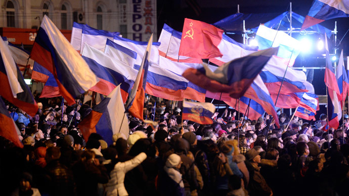 Pro-Russian Crimeans wave Russian flags as they gather to celebrate in Simferopol's Lenin Square on March 16, 2014 after exit polls showed that about 93 percent of voters in Ukraine's Crimea region supported union with Russia.(AFP Photo / Dimitar Dilkoff)