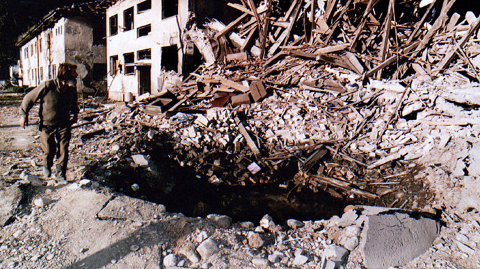 A Bosnian Serb man surveys damage near the town of Brod September 8, following a NATO air raid here two days ago. (Reuters)