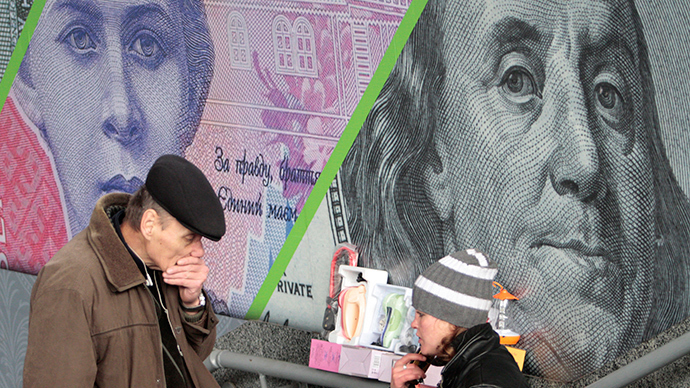A customer and street vendor are seen before the background of an outdoor ad with an image of the Ukrainian hryvnia and U.S. dollar bank notes in central Kiev (Reuters / Anatolii Stepanov)