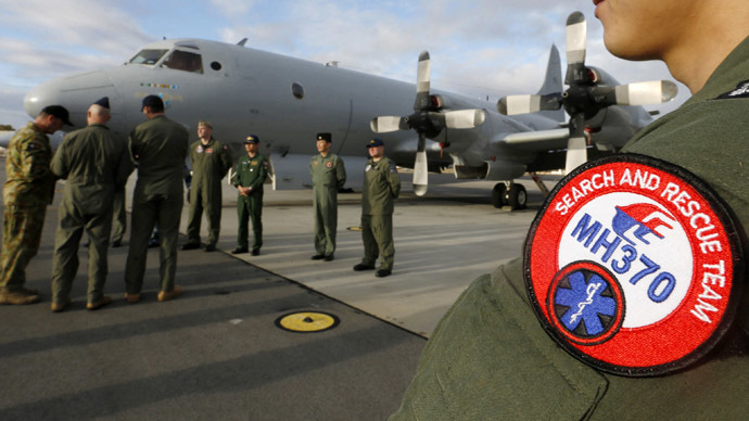 South Korea's Navy Lieutenant Commander Oh Kang-min (R) is pictured wearing a Malaysia Airlines flight MH370 search and rescue team patch on his sleeve as he waits to meet Australia's Prime Minister Tony Abbott in front of a Royal Australian Air Force AP-3C Orion aircraft at RAAF Base Pearce near Perth March 31, 2014. (Reuters)