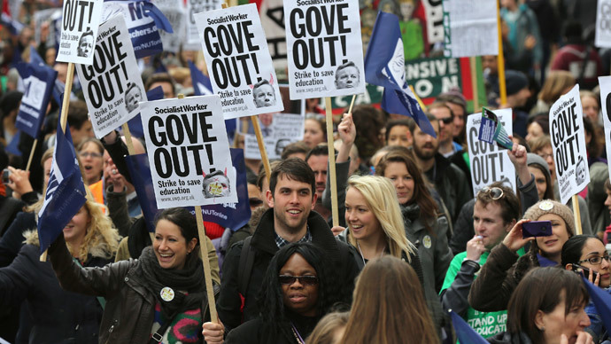 Teachers hold placards and banners during a march in central London March 26, 2014. (Reuters / Paul Hackett)