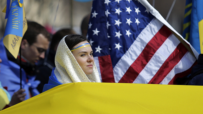 Woman is surrounded by Ukraine and US flags during protest in Lafayette Square in Washington (Reuters / Gary Cameron)
