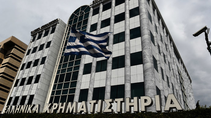 A Greek flag waves outside the Athens stock exchange on April 10, 2014. (AFP Photo / Aris Messinis)