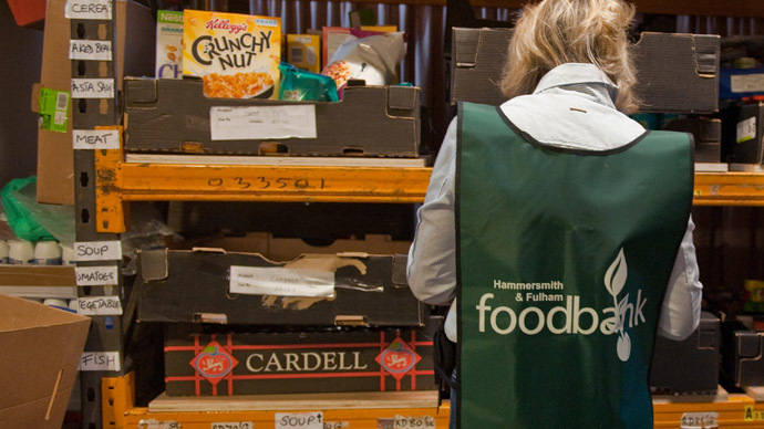 A volunteers sorts through donations of food at the Hammersmith and Fulham food bank run by the Trussell Trust in London (AFP Photo/Will Oliver)