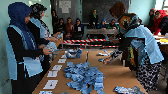 Election officials hold a ballot paper during the vote counting process at a polling station in Herat Province, April 5, 2014 (Reuters / Omar Sobhani)