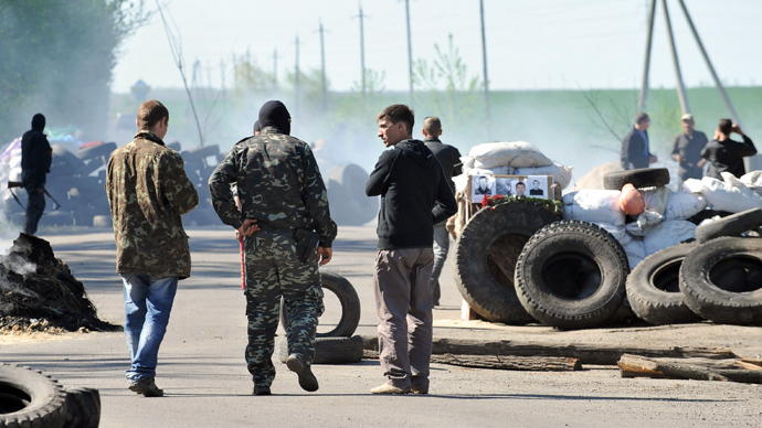 Armed anti-goverment activists stand guard next to a barricade at a checkpoint outside the eastern Ukrainian city of Slavyansk on April 24, 2014 after Ukrainian troops left (AFP Photo)