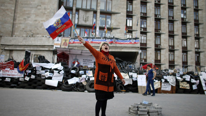 A pro-federalization protester shout slogans as she waves a Russian flag outside a regional government building in Donetsk, in eastern Ukraine April 23, 2014. (Reuters)