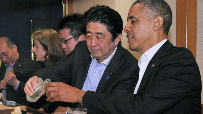 Japanese Prime Minister Shinzo Abe (2nd R) pours sake for U.S. President Barack Obama (R) as they have dinner at the Sukiyabashi Jiro sushi restaurant in Tokyo, in this picture taken April 23, 2014, and released by Japan's Cabinet Public Relations Office. (Reuters)