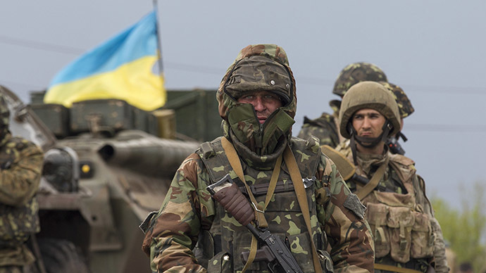 A Ukrainian soldier stands guard near an armoured personnel carrier at a checkpoint near the town of Slaviansk in eastern Ukraine May 2, 2014. (Reuters / Baz Ratner)