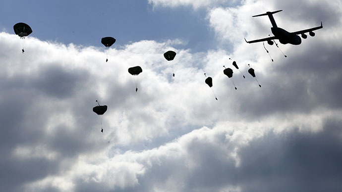 Troops from the U.S. Army's 173rd Infantry Brigade Combat Team parachute from a Boeing C-17 Globemaster III during a NATO-led exercise "Orzel Alert" held together with Canada's 3rd Battalion and Princess Patricia's Light Infantry, and Poland's 6th Airborne Brigade in Bledowska Desert in Chechlo, near Olkusz, south Poland May 5, 2014. (Reuters / Kacper Pempel)