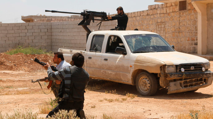 A Free Syrian Army fighter mans an anti-aircraft gun on the back of a pick-up truck during clashes with forces loyal to Syria's President Bashar al-Assad in Sheikh Najjar in Aleppo May 13, 2014. (Reuters / Hosam Katan)