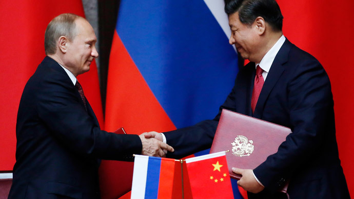 Russia's President Vladimir Putin (L) and China's President Xi Jinping shake hands after signing an agreement during a bilateral meeting at the Xijiao State Guesthouse ahead of the fourth Conference on Interaction and Confidence Building Measures in Asia (CICA) summit, in Shanghai May 20, 2014.(Reuters / Carlos Barria)