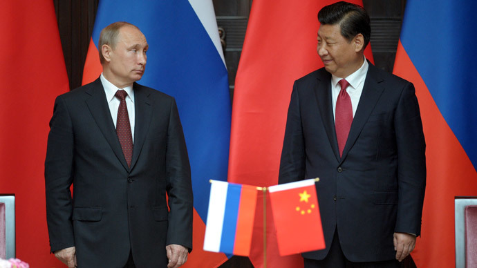 Russia's President Vladimir Putin (L) and China's President Xi Jinping attend an agreement signing ceremony during a bilateral meeting at Xijiao State Guest house ahead of the fourth Conference on Interaction and Confidence Building Measures in Asia (CICA) summit, in Shanghai on May 20, 2014.(AFP Photo / Alexey Druzhinin)