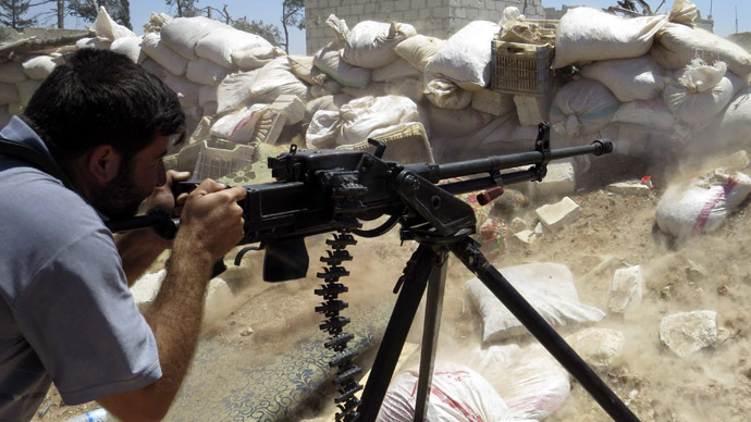 A Free Syrian Army fighter fires his weapon towards forces loyal to Syria's President Bashar al-Assad in Mork, northern Hama countryside May 18, 2014. Picture taken May 18, 2014. (Reuters)