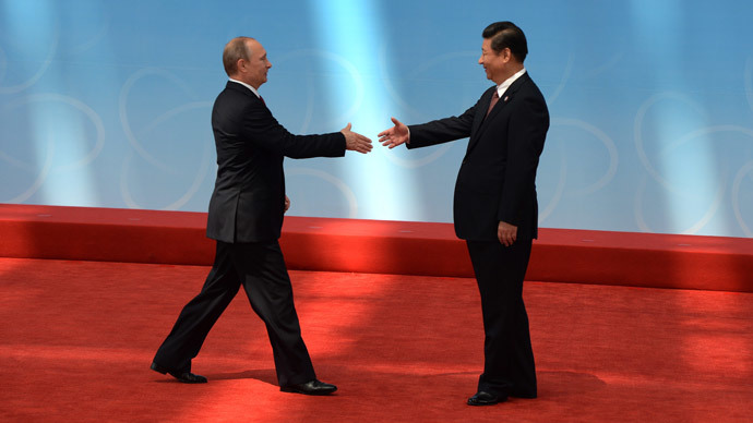 Russian President Vladimir Putin (L) is greeted by Chinese President Xi Jinping before the opening ceremony at the Expo Center at the fourth Conference on Interaction and Confidence Building Measures in Asia (CICA) summit in Shanghai on May 21, 2014. (AFP Photo / Mark Ralston)