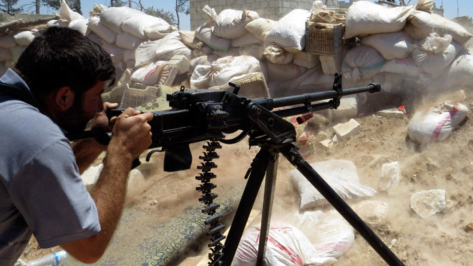 A Free Syrian Army fighter fires his weapon towards forces loyal to Syria's President Bashar al-Assad in Mork, northern Hama countryside May 18, 2014.(Reuters / Stringer)