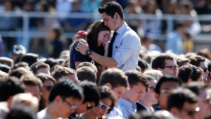 Students console one another at the University of California Santa Barbara's Harder Stadium during a memorial service in honor of the victims of Friday's Isla Vista rampage in Santa Barbara, California, May 27, 2014. (Reuters / Lucy Nicholson)