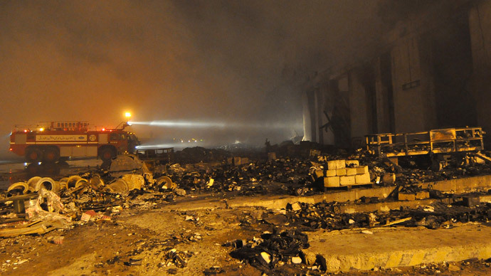 A freighter vehicle is seen at the site damaged by Sunday's Taliban attack on Jinnah International Airport in Karachi June 9, 2014.(Reuters / Stringer)