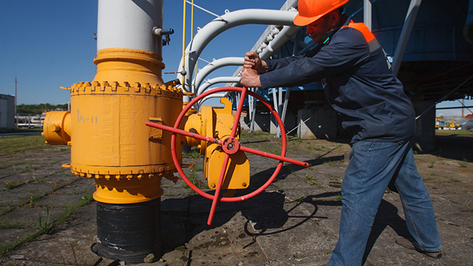 An employee tightens the valve on a pipeline at the Bilche-Volytsko-Uherske underground gas storage facility, the largest in Europe, not far from the village of Bilche village, in the Lviv region of western Ukraine, on May 21, 2014. (AFP Photo / Alexander Zobin)