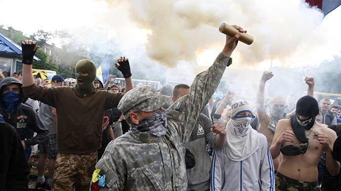 Protesters burn fayers during rally against Russian President Vladimir Putin in front of the Russian embassy in Kiev on June 14, 2014. (AFP Photo / Yuriy Kirnichny)