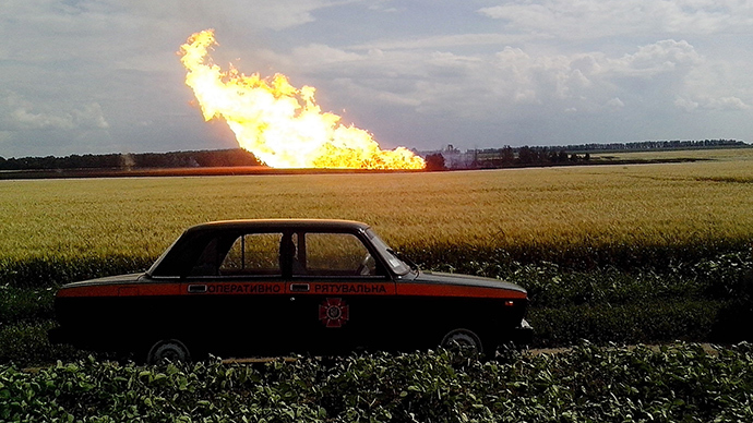 This handout picture taken and released by the Ukrainian Emergency Service on June 17, 2014 shows a police car parked beside a field near a fire on the gas pipeline the village of Iskivtsi in the Lokhvytsia region (AFP Photo)