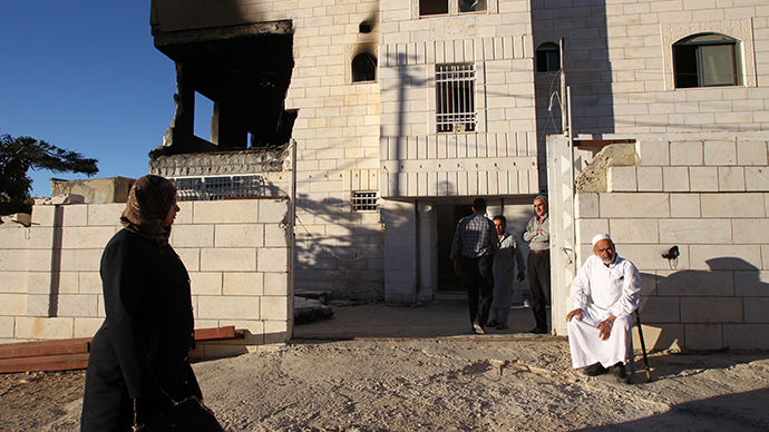 Relatives gather outside the house of Amer Abu Eishe, a Palestinian member of the Islamist Hamas in Hebron named by Israel as one of the two prime suspects in the murder of three kidnapped Israeli teenagers on July 1, 2014 in the West Bank town of Hebron, after the house was blown up by Israeli army (AFP Photo / Hazem Bader)