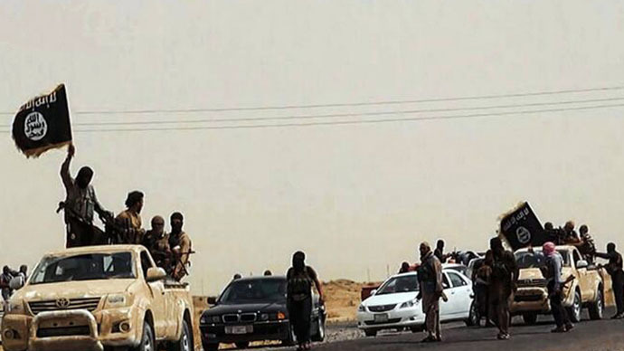 An image uploaded on June 14, 2014 on the jihadist website Welayat Salahuddin allegedly shows militants of the Islamic State of Iraq and the Levant (ISIL) driving on a street at unknown location in the Salaheddin province. (AFP Photo)