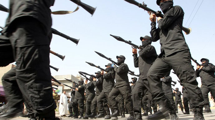 A file picture taken on June 21, 2014 shows Iraqi Shiite fighters parading with their weapons in the capital Baghdad. (AFP Photo / Ali al-Saadi)