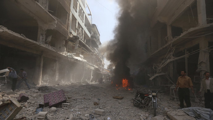 Smoke rises from fire at a site after what activists said were two air strikes by forces of Syria's President Bashar al-Assad on a market in central Douma, eastern al-Ghouta, near Damascus September 17, 2014. (Reuters/Bassam Khabieh)