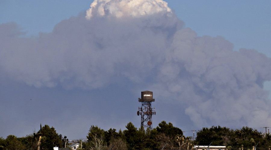 Cars ablaze as 3,500-acre California brush fire swallows freeway, homes