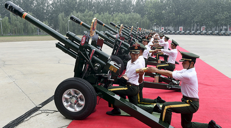 Paramilitary policemen and members of a gun salute team load cannons during a training session for a military parade to mark the 70th anniversary of the end of the World War Two, at a military base in Beijing, China, August 1, 2015 © HO