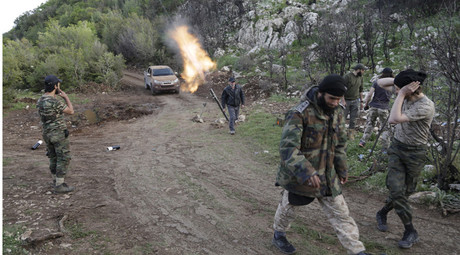 Rebel fighters fire mortar shells at the frontline in the Jabal al-Akrad area in Syria's northwestern Latakia province. © Khalil Ashawi