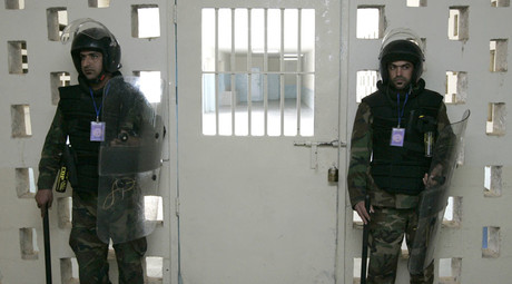 Guards stand guard at a gate in the Baghdad Central Prison in Baghdad's Abu Ghraib. © Mohammed Ameen