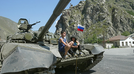 ARCHIVE PHOTO: Children sit on a Russian tank near the South Ossetian city of Tskhinvali on August 10, 2008 © Said Gutziev