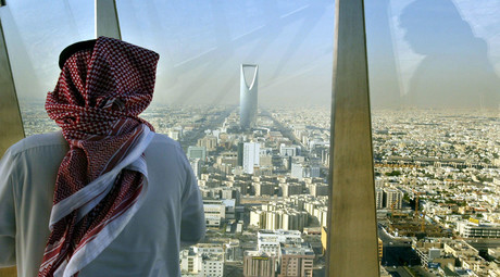 A man looks at central Riyadh from the Faisaliah Tower, Saudi Arabia. © Peter MacDiarmid