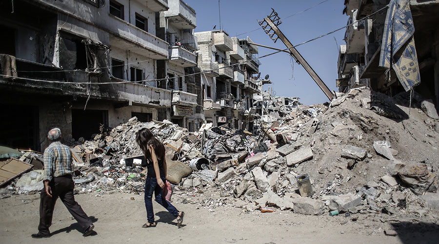 The Syrian Christians, father and daughter, are visiting their house abandoned them during the military action in the center of Homs. © RIA Novosti