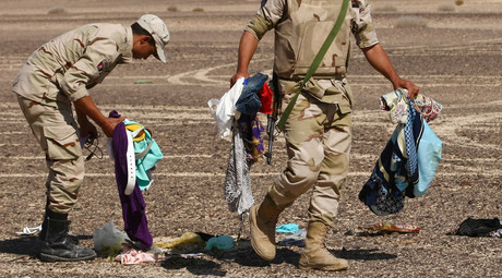 Servicemen gather passengers' belongings on the crash site of the Airbus A321 that was carrying out Kogalymavia Flight 9268 from Sharm el-Sheikh to St. Petersburg, 100 km south of El Arish in the northern Sinai Peninsula. © Maxim Grigoryev