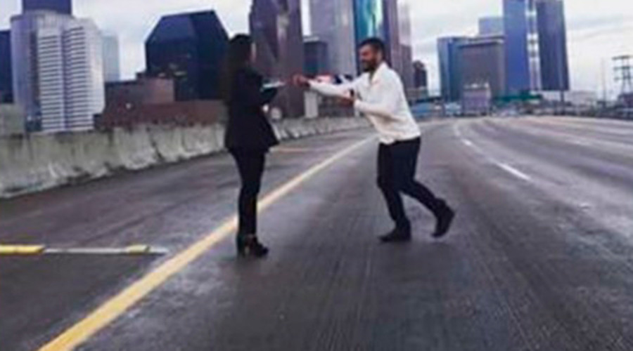 Romantic proposes on America’s busiest freeway, now faces charges
