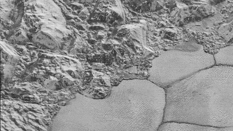 The Mountainous Shoreline of Sputnik Planum: In this highest-resolution image from NASA’s New Horizons spacecraft, great blocks of Pluto’s water-ice crust appear jammed together in the informally named al-Idrisi mountains. © NASA/JHUAPL/SwRI