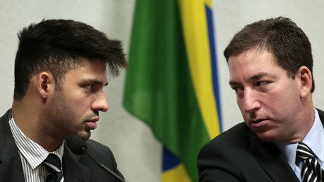 Glenn Greenwald (R), American journalist, speaks with partner David Miranda. © Ueslei Marcelino