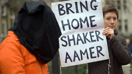 A protestor holds up a sign calling for the release of Shaker Aamer from the Guantanamo prison during a demonstration in central London. © Leon Neal