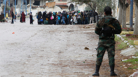 Syrian Army soldiers monitor residents who said they have received permission from the Syrian government to leave the besieged town as they wait with their belongings after an aid convoy entered Madaya, Syria, January 14, 2016 © Omar Sanadiki 