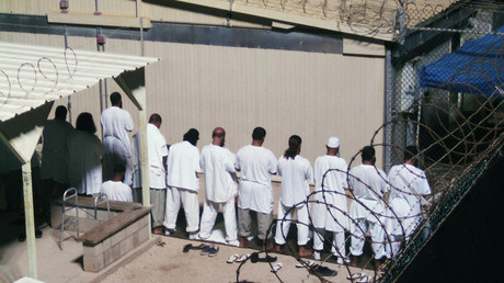 Detainees participate in an early morning prayer session at Camp IV at the detention facility in Guantanamo Bay U.S. Naval Base © Deborah Gembara 