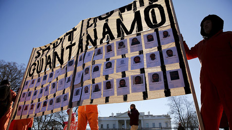 Protesters in orange jumpsuits from Amnesty International USA and other organizations rally outside the White House to demand the closure of the U.S. prison at Guantanamo Bay, in Washington January 11, 2016. © Jonathan Ernst