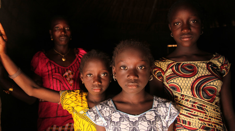 A woman and her daughters stand in their home, in the village of Cambadju in Bafatá Region. © unicef.org