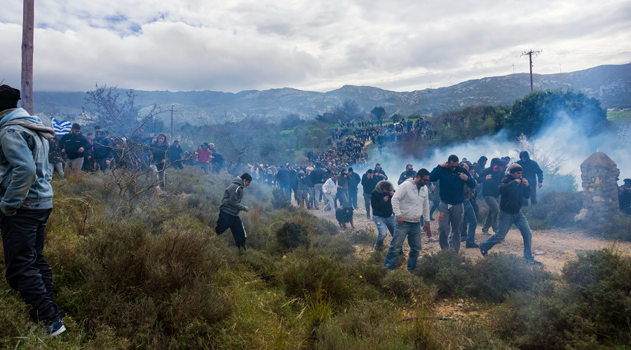 Greek police fire tear gas at rally protesting construction of refugee center on tourist island