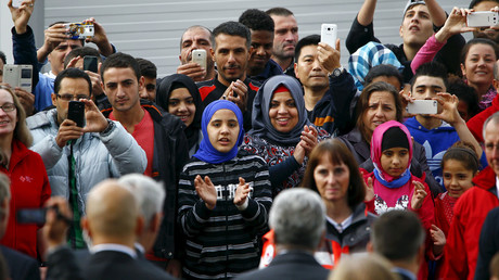 Migrants applaud and take pictures with their mobile phones as German President Joachim Gauck arrives at a provisional tent home for refugees in Bergisch Gladbach near Cologne, Germany. © Wolfgang Rattay